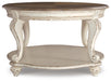 Ashley Express - Realyn Oval Cocktail Table - DecorGalore4U