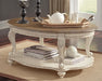 Ashley Express - Realyn Oval Cocktail Table - DecorGalore4U